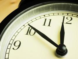 Alarm Clock on wooden background photo