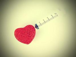 Tear syringe down to the red heart photo