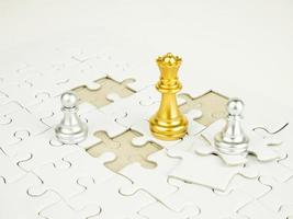 Glod and Sliver chess piece on jigsaw puzzle background, business concept photo