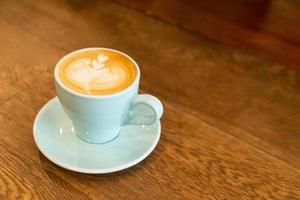 hot latte coffee cup on table photo