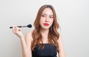 portrait beautiful woman with makeup brush photo