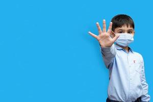 Little boy saying Stop with his hand isolated on a plain background copy space photo