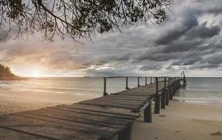 Sea wooden bridge and raining clouds. photo