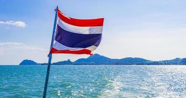 The national flag of Thailand in rough wind blue sky. photo
