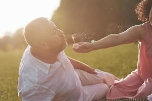 A loving, handsome senior couple outdoors in the park, many years together photo