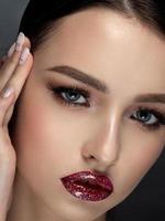 Woman with glittery red lips closeup portrait photo