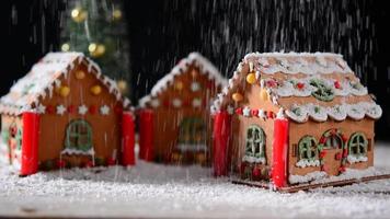 Falling snow on gingerbread house
