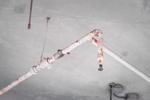 A water pipe to extinguish sparks or fire in a department store building is installed above the ceiling. Safety concept. photo