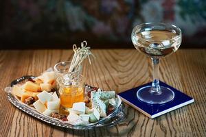 different type of cheese on the tray and cocktail photo