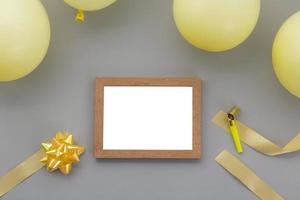 Happy birthday background, Flat lay party decoration with photo frame on pastel grey background