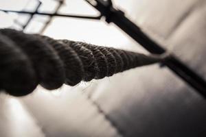 Brown climbing rope hanging from roof photo