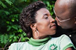 Couple kissing outdoors photo