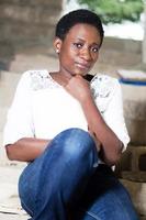 young woman sitting pensively photo