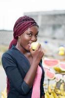 smiling young woman eating an apple. photo
