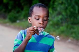 child blowing bubbles. photo