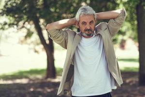 Mature man, model of fashion, in an urban park. photo
