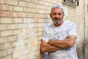 Mature man smiling looking at camera in urban background photo