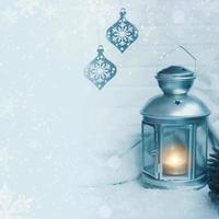 Christmas lantern with snowfall Christmas background with pine cones and decoration copy space photo