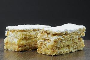 puff pastry cakes on wooden table photo