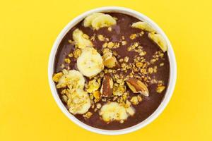 brazilian nuts on white bowl with banana photo