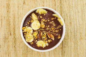 brazilian nuts on white bowl with banana photo