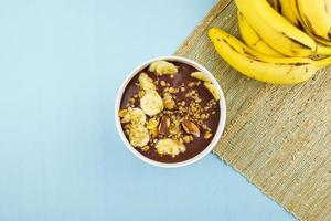 brazilian nuts on white bowl with banana photo