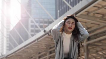 Lay off. Sacked. Fired business woman sitting on stairs of office building outside. photo