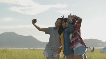 Asian women taking selfies at summer travel video