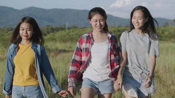 Asian women holding hands, walking, having fun together at summer travel video