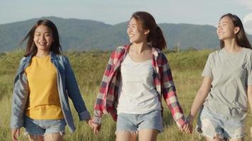 Asian women holding hands, walking, having fun together at summer travel video