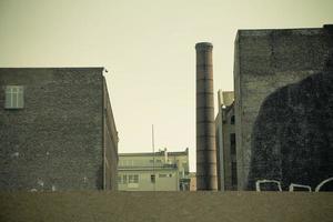 Old factory building with industrial brick chimney photo