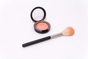 Close up of makeup brush and blush box isolated on white background photo