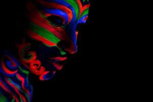 Woman with make up art of glowing UV fluorescent powder photo