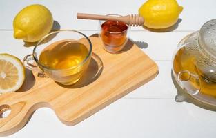 hot afternoon tea with honey and lemon served on table in cafe photo