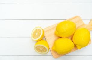 view from above of fresh lemon on whte table photo