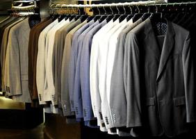 Raw of different colors man's jackets hanging photo