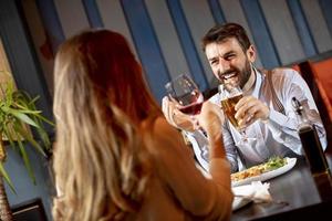 Beautiful loving couple is spending time together in modern restaurant photo
