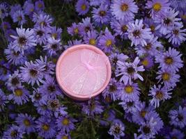 Small gift box on a background of blue flowers photo