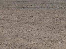 Texture of the land plowed by a plow field photo