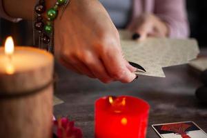 Fortune teller reading a future by tarot cards photo