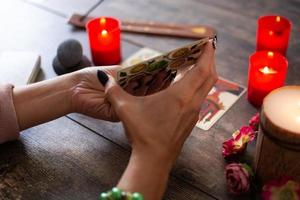 Fortune teller reading a future by tarot cards photo