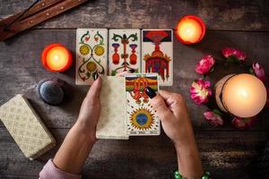 Fortune teller reading a future by tarot cards photo