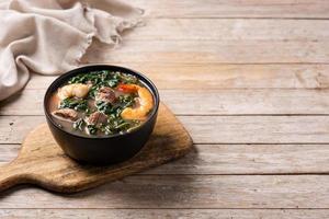 Beef, okra stew and spinach soup in bowl photo