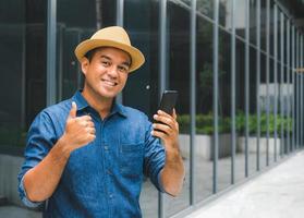 Young asian man using smartphone. photo