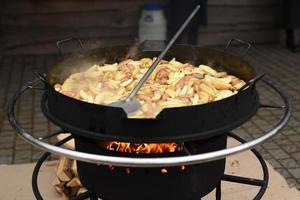 fried potatoes in a huge wok photo