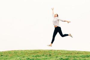 young woman, jumping against sky backgroung, freedom concept photo