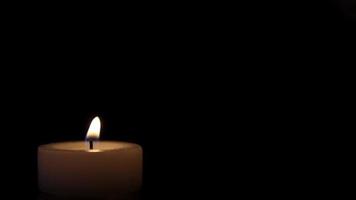 Shot of a candle burning, isolated on black background video