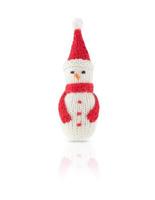 Knitted Christmas snowman in red hat and scarf isolated on white background, with shadow and reflection. photo