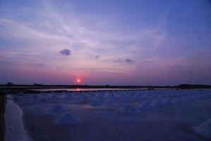 Beautiful sunset salt farming Naklua in the coastal, Phetchaburi provinces of Thailand photo