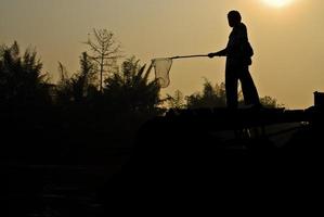 The boy stand on pontoon and  fishing photo